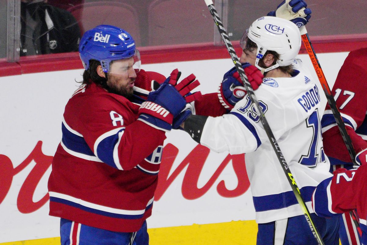 Montreal Canadiens defenseman Ben Chiarot (8) and Tampa Bay Lightning right wing Barclay Goodrow (19) throw punches after a stop in play during the third period of Game 4 of the NHL hockey Stanley Cup final in Montreal, Monday, July 5, 2021.  (Paul Chiasson)