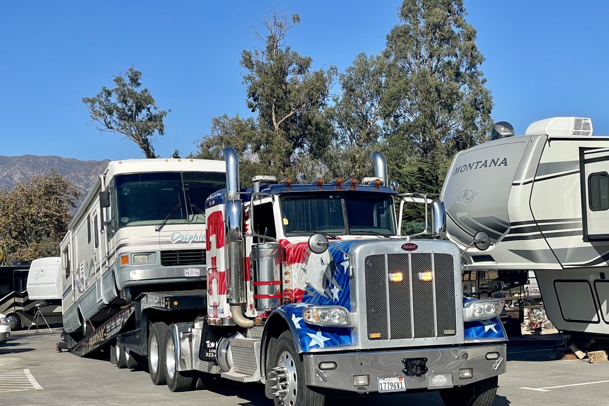 What’s happening? Lookieloos need to watch, in this case as a big rig hauls an RV from tight quarters at Carpinteria State Beach in California. (Leslie Kelly)