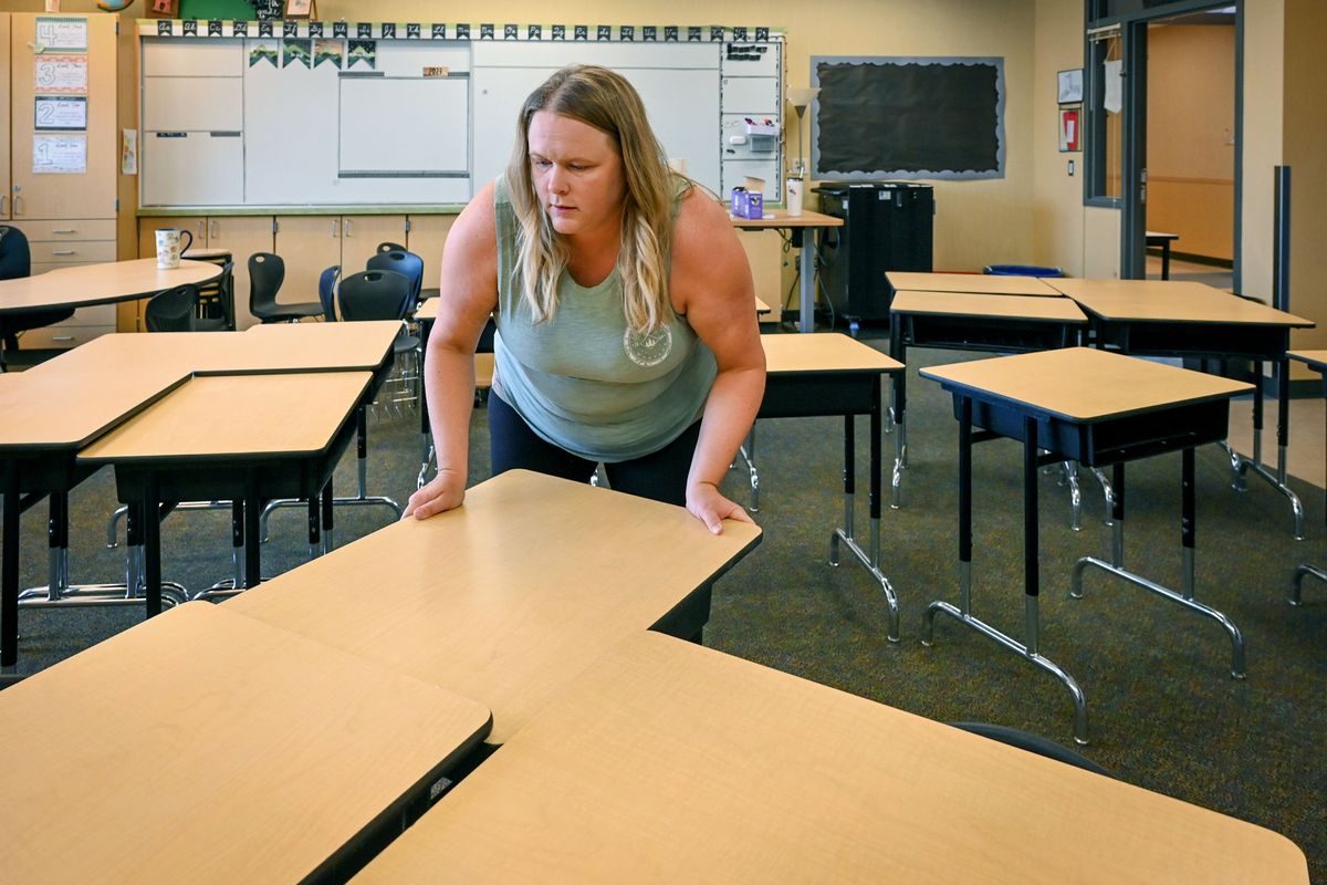 Freeman Elementary School fourth-grade teacher Desiree Hendrickson moves students desks into position as she sets up her classroom on Wednesday, Aug. 16, 2023, in preparation for the start of school on Aug. 30. Hendrickson will be beginning her 10th year at Freeman.  (DAN PELLE/THE SPOKESMAN-REVIEW)