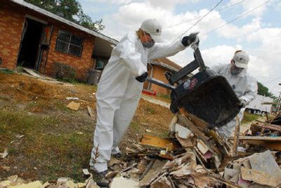 
PGA Tour golfer Aaron Baddeley's wife Richelle, left, helps gut a house in New Orleans for Catholic Charities.
 (Associated Press / The Spokesman-Review)