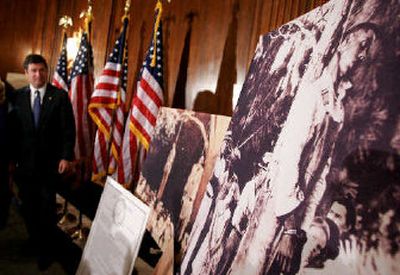 
Sen. George Allen, R-Va., looks at photos of lynching victims before the Senate apologized in Washington, D.C., on Monday.
 (Associated Press / The Spokesman-Review)