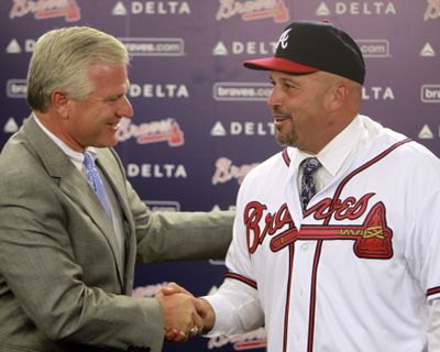 Atlanta Braves general manager Frank Wren, left, greets new manager Fredi Gonzalez, the replacement for Bobby Cox.  (Associated Press)