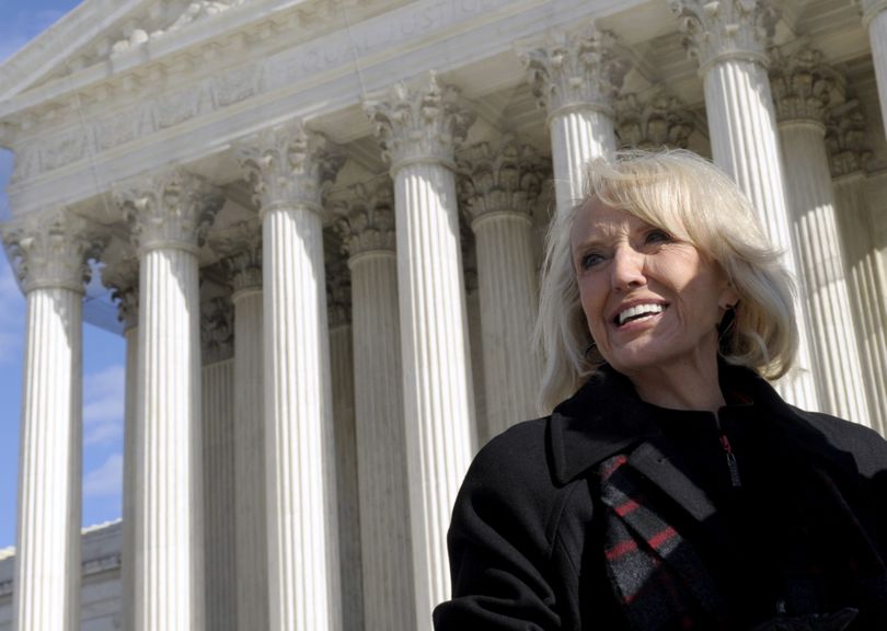 Arizona Gov. Jan Brewer stands outside the Supreme Court in Washington on Wednesday,  after attending arguments  regarding the Arizona employer sanctions law.  (Associated Press)