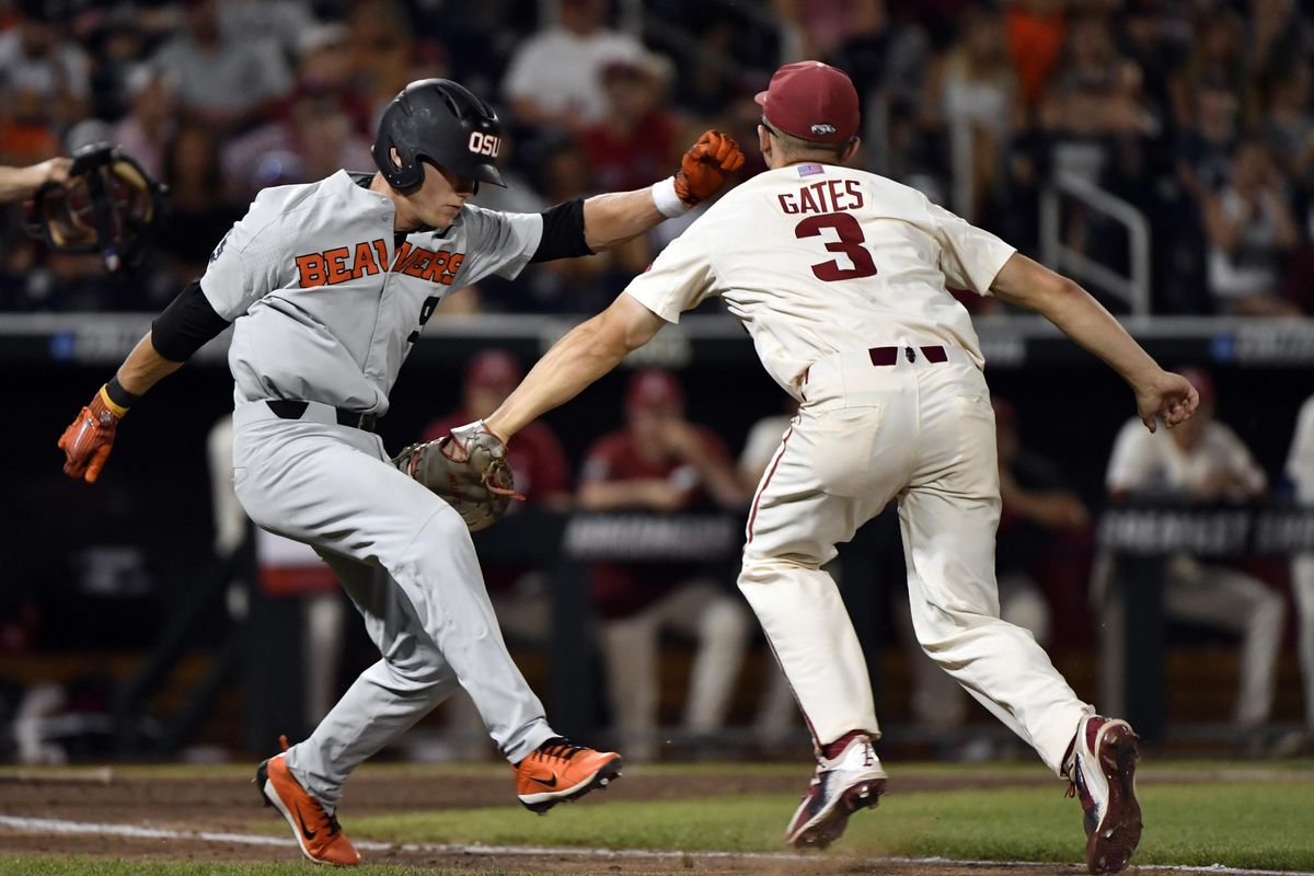 Oregon State’s Andy Armstrong (9) is tagged out by Arkansas’ Jared Gates (3) during the ninth inning in Game 2 of the NCAA College World Series baseball finals in Omaha, Neb., Wednesday, June 27, 2018. (Ted Kirk / Associated Press)