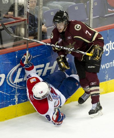 Spokane Chiefs Tyler Johnson (7) is elbowed by Chilliwack's Tyler Stahl (9) in the second period of their WHL first round playoff  match, Wednesday, March 30, 2011, in the Spokane Arena. Stahl was given a five minute penalty and a game misconduct. (Colin Mulvany / The Spokesman-Review)