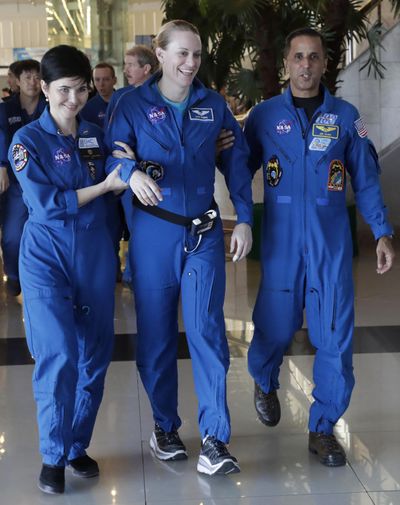 U.S. astronaut Kate Rubins is assisted by NASA space agency specialists at the airport in Karaganda, Kazakhstan, Sunday, Oct. 30, 2016. (Dmitri Lovetsky / Associated Press)