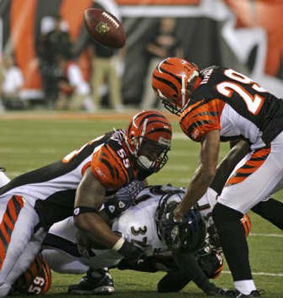 Cincinnati's defense – Ahmad Brooks, left, and Leon Hall force Le'Ron McClain to fumble – had a lot to do with the Bengals' 27-20 win. Associated Press
 (Associated Press / The Spokesman-Review)