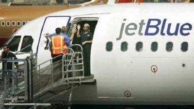 
 JetBlue airline's crew members wave goodbye as a flight prepares to depart Bob Hope Airport in Burbank, Calif. Travelers ranked JetBlue Airways Corp. their favorite low-cost carrier and Continental Airlines Inc. the best of the traditional full-service carriers, according to a survey released Thursday. 
 (Associated Press / The Spokesman-Review)