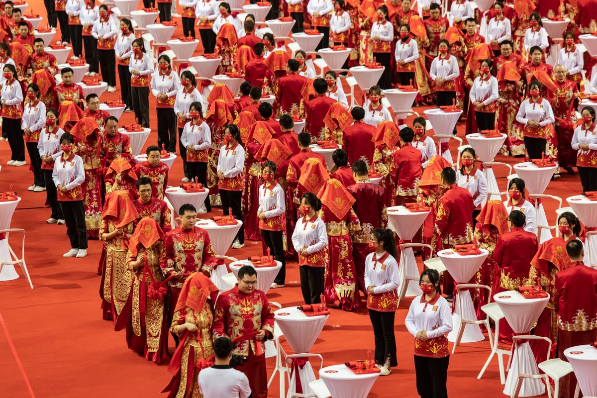 A mass wedding to encourage residents to resist “bad habits,” such as high “bride prices,” payments that grooms make to their prospective wives’ families, in Nanchang, China, on March 8. Grooms are now paying more money for wives, in a tradition that has faced growing resistance.  (QILAI SHEN)