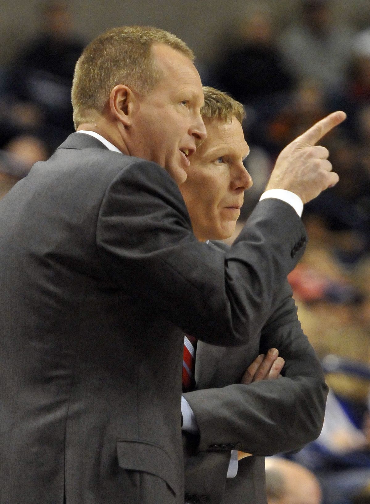 Gonzaga coach Mark Few, right, who counts heavily on his assistants for game planning and strategy, receives some input from Ray Giacoletti during a recent game at McCarthey Athletic Center. (Jesse Tinsley)