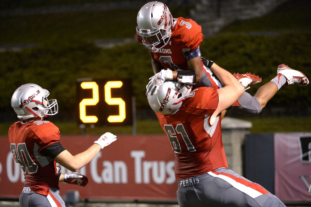 Ferris’ Caleb Heath hoists RB Jalen Hicks, right, after Hicks scored one of his five rushing TDs on Friday. Hicks ran for a school-record 360 yards, third in GSL history. (JESSE TINSLEY PHOTOS)