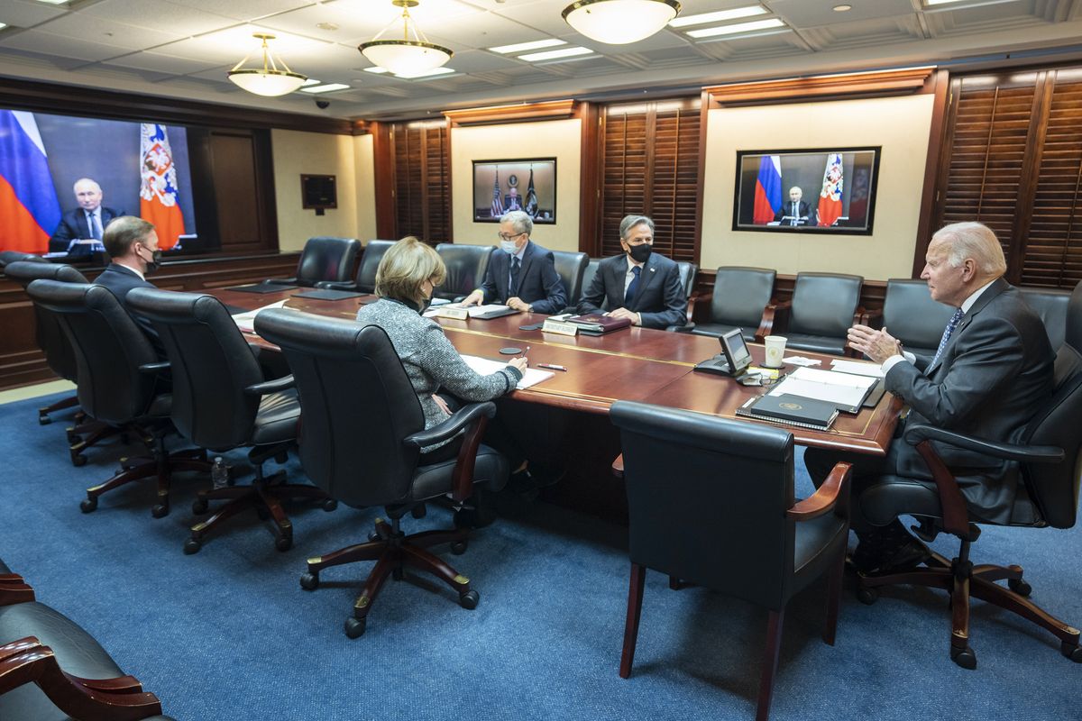 In this image provided by The White House, President Joe Biden speaks as he meets virtually via a secure video conference with Russian President Vladimir Putin from the Situation Room at the White House in Washington, Tuesday, Dec. 7, 2021. At far left is White House national security adviser Jake Sullivan along with Secretary of State Antony Blinken, right, national security council senior director for Russian and Central Asia, Eric Green. (Adam Schultz)