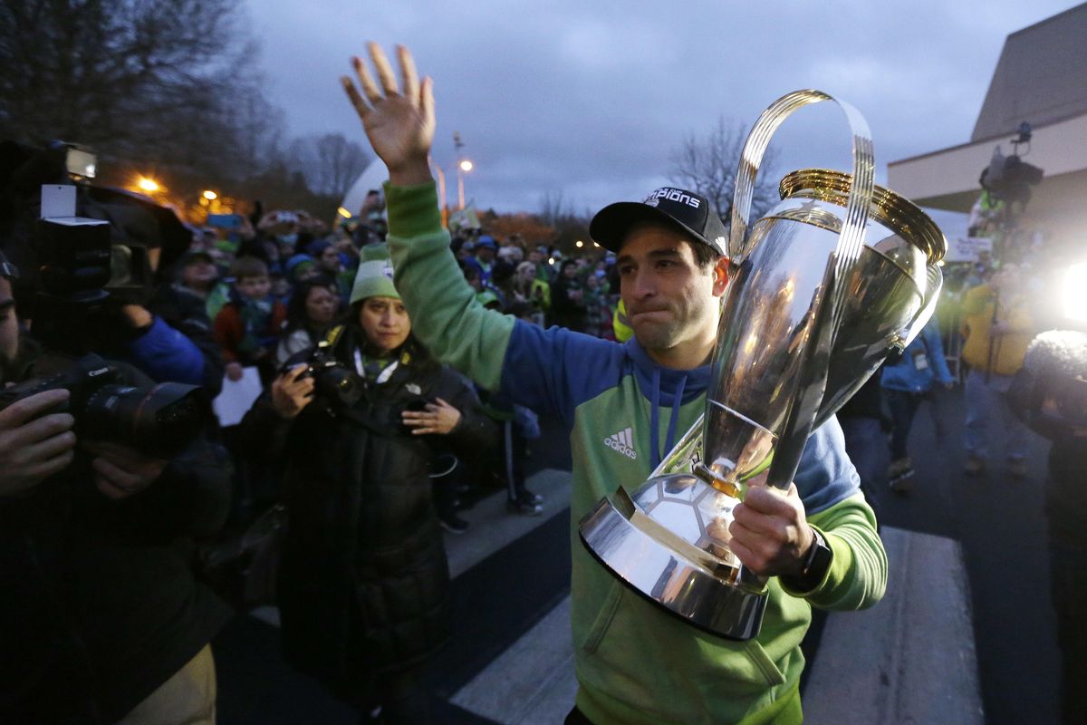 Seattle Sounders forward Nicolas Lodeiro holds the MLS Cup as he greets fans at the King County Airport in Seattle on Sunday, Dec. 11, 2016, after the MLS soccer team returned from Toronto, where they beat Toronto FC Saturday to win the MLS Cup. (Ted S. Warren / Associated Press)