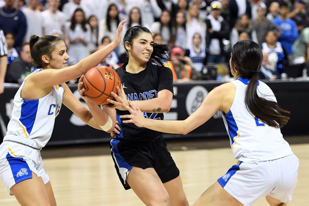 Colfax’s Lauryn York on left and Asher Cai on right, double team Warden’s Kiana Rios as she looks to pass during a State 2B girls basketball championship game, Saturday, March 5, 2022, in the Spokane Arena.  (COLIN MULVANY/THE SPOKESMAN-REVIEW)