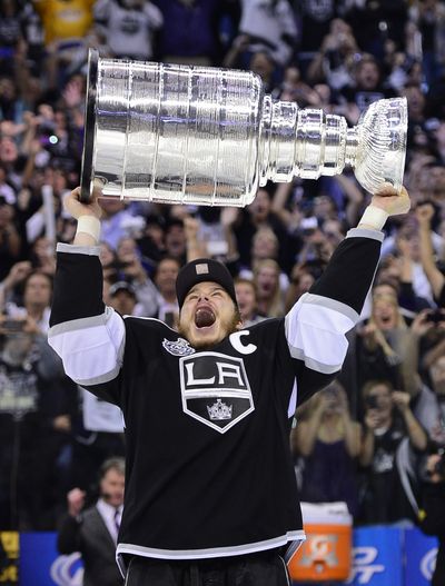 Los Angeles Kings captain Dustin Brown hoists the Stanley Cup after the Kings beat the visiting New Jersey Devils 6-1 during Game 6 of the NHL hockey Stanley Cup finals, Monday, June 11, 2012. (Associated Press)