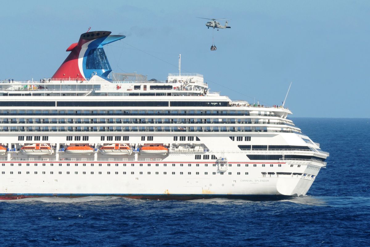 This Nov. 9, 2010 photo released by the U.S. Navy, shows an HH-60H Sea Hawk helicopter from the Black Knights of Helicopter Anti-Submarine Squadron (HS) 4 delivering pallets of supplies to the Carnival cruise ship Splendor off the coast of San Diego.  (Courtesy of U.S. Navy / Ho)