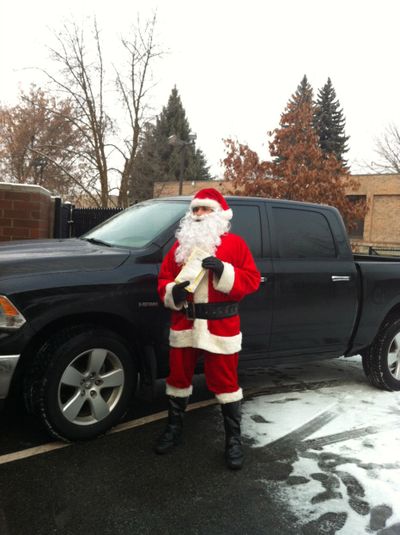 Mike Finocchiaro, dressed as Santa, holds his $450 ticket for parking in a handicapped space at St. Margaret’s Shelter on Christmas Eve.