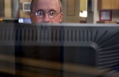 
Lakeland Assistant Superintendent Ron Schmidt demonstrates new software the district has purchased for all of its elementary and junior high schools on Wednesday. Visitors will have to present their driver's licenses, which will be scanned into a machine and checked against sex offender registries. 
 (Kathy Plonka / The Spokesman-Review)
