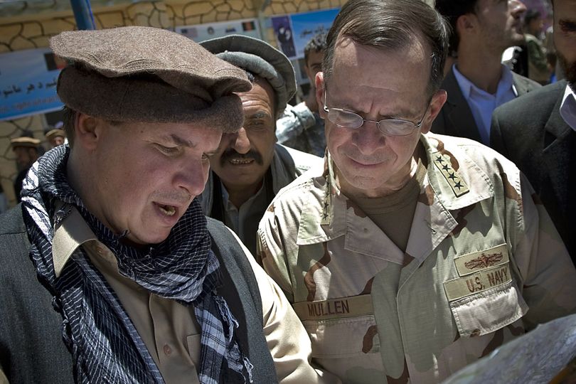 In this July 2009 photo, “Three Cups of Tea” co-author Greg Mortenson, left, shows the locations of future village schools to U.S. Navy Adm. Mike Mullen, chairman of the Joint Chiefs of Staff, at the opening of Pushghar Village Girls School in Panjshir Valley, Afghanistan. (Associated Press)