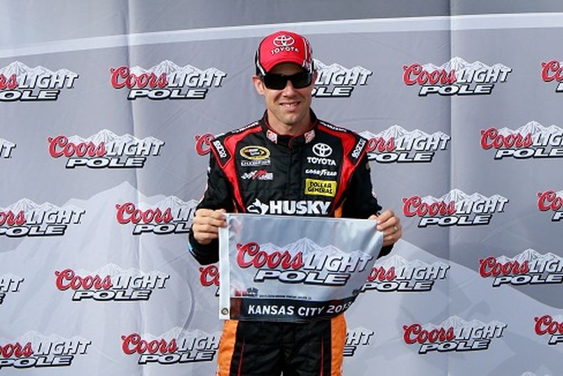 Matt Kenseth, driver of the #20 The Home Depot/Husky Toyota, poses with the Coors Light Pole award after qualifying for pole position for the NASCAR Sprint Cup Series STP 400 at Kansas Speedway on April 19, 2013 in Kansas City, Kansas. (Photo Credit: Chris Trotman/Getty Images) (Chris Trotman / Getty Images North America)