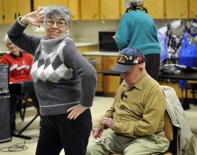 Jane Ashley dances and Kenny Tews plays the spoons during a Hillyard Belles practice Feb. 2 at the Hillyard Senior Center.