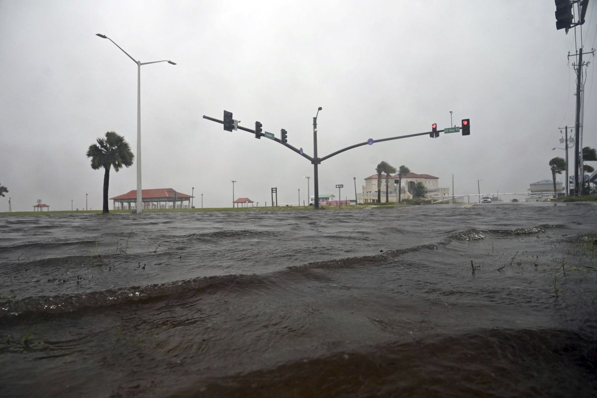 A storm surge covers U.S. 90 in Long Beach, Miss., on the Mississippi Gulf Coast as Tropical Storm Cristobal makes landfall Sunday, June 7, 2020.  (Lukas Flippo)