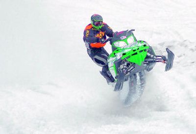
Ty Free, of Bozeman, leans off one side of his machine and barrels up the face of the Lookout Pass Ski Resort hill during the Race the Face hill climb Saturday. The popular race drew snowmobilers from around the region. 
 (Jesse Tinsley / The Spokesman-Review)