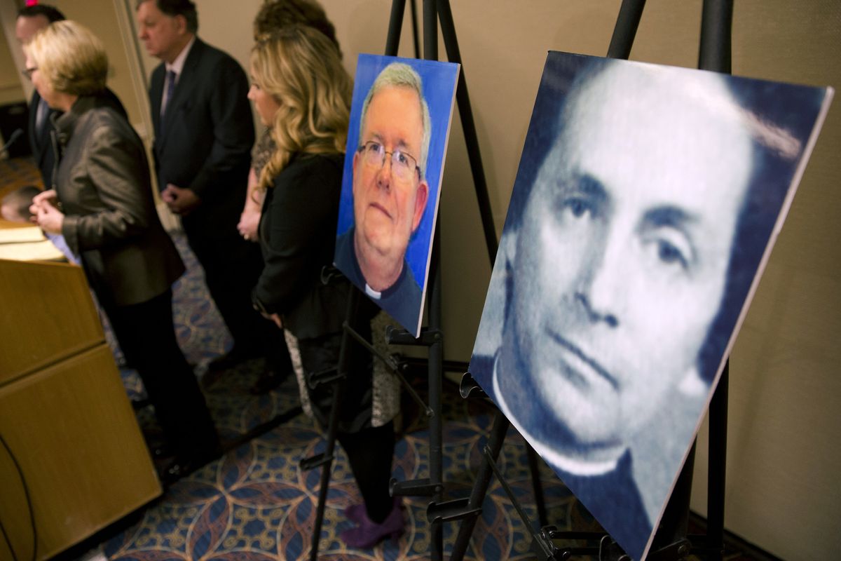 FILE - In this Nov. 13, 2013, file photo, a photo of Rev. Robert Brennan, right, is displayed during a news conference in Philadelphia. Federal prosecutors in Philadelphia charged Brennan, a former Roman Catholic priest with lying to the FBI about whether he knew the accuser and his family. Two years ago U.S. attorney William McSwain in Philadelphia joined the long line of ambitious prosecutors investigating the Roman Catholic church