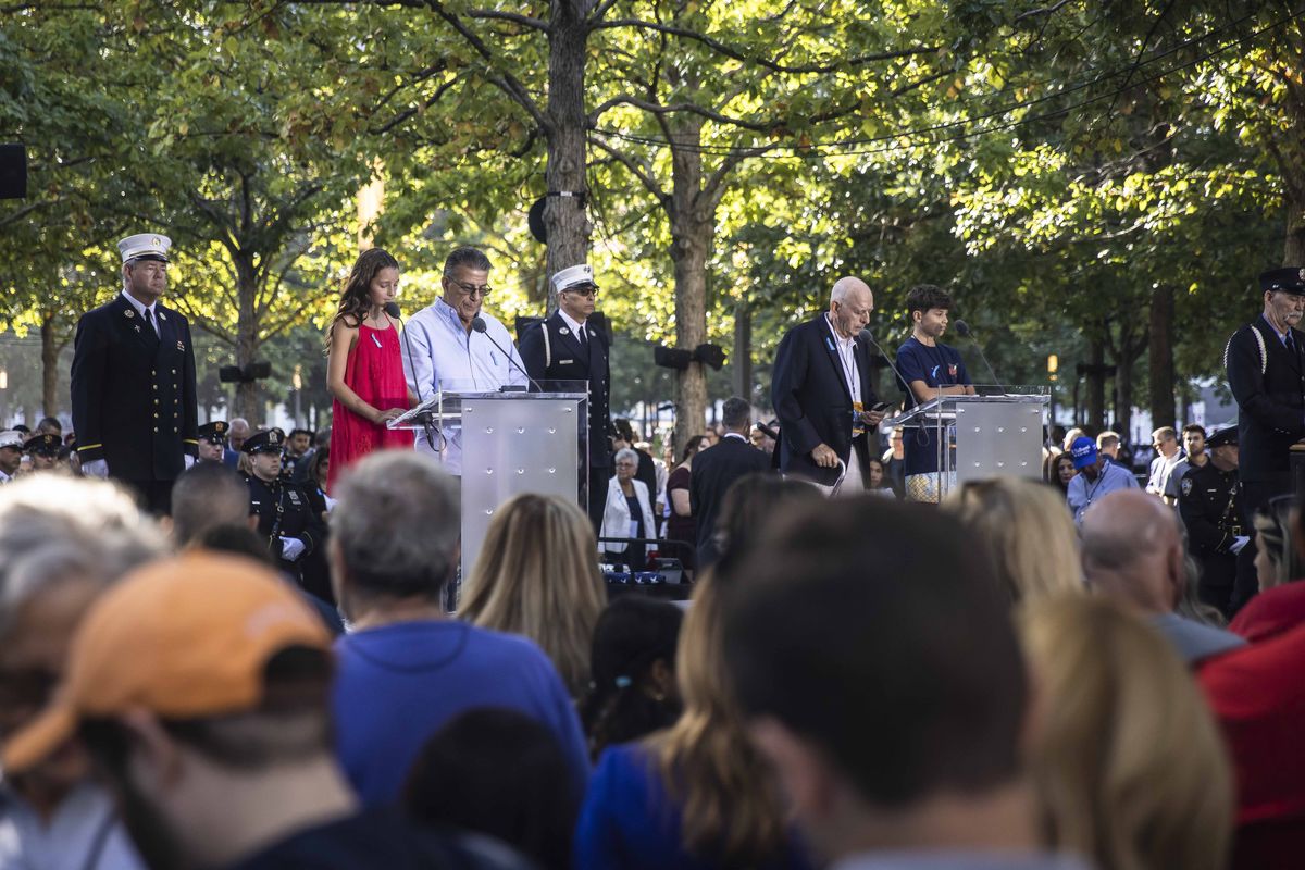 Names of victims are read at the 9/11 Memorial & Museum on the 23rd anniversary of the Sept. 11, 2001 terror attacks, in Manhattan on Sept. 11, 2024. About one-third of readers at the 2024 service belong to a new generation in the Sept. 11 families, one with no memory of the attacks but increasingly shouldering the responsibility to never forget. (Dave Sanders/The New York Times)