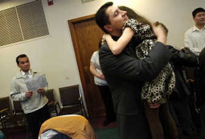 
George Mendoza hugs his daughter Sophia, 8, after becoming a citizen at the U.S. post office courtroom  in Spokane on Tuesday. 
 (Rajah Bose / The Spokesman-Review)