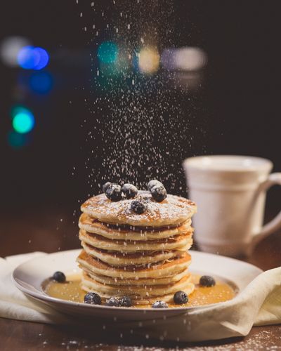 For a bit more sweetness and pretty presentation, use a sieve to sprinkle powdered sugar over the pancakes.  (Pixabay)