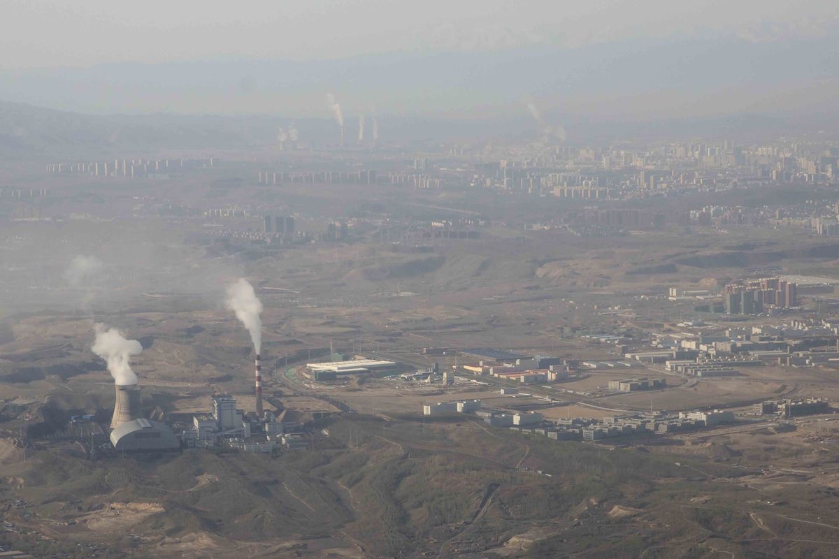 FILE - Smoke and steam rise from towers at the coal-fired Urumqi Thermal Power Plant in Urumqi in western China