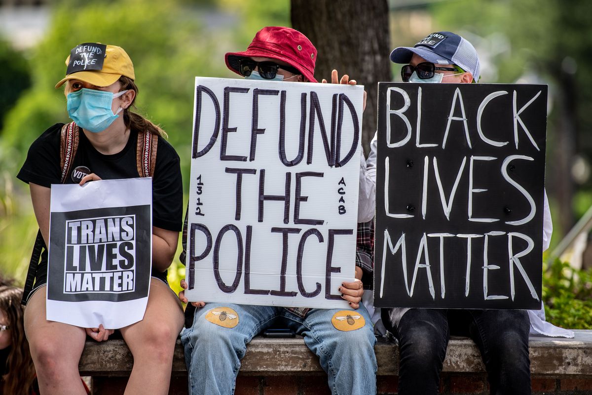 About 70 people gathered outside Spokane City Hall to protest a proposed contract with the Spokane Police Guild on Monday, June 29, 2020.  (Colin Mulvany / The Spokesman-Review)