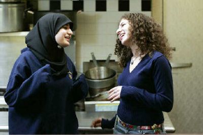 
Rana Abdallah, 14, left, and Annie Rose London, 16, talk at the Palisades Emergency Residence Corp., a 40-bed shelter for single, homeless people, in Union City, N.J. Abdallah, a Muslim, and London, a Jew, are part of a group of about 20 Muslim and Jewish girls who have been meeting since May to help set up a shelter for homeless families.
 (Associated Press / The Spokesman-Review)