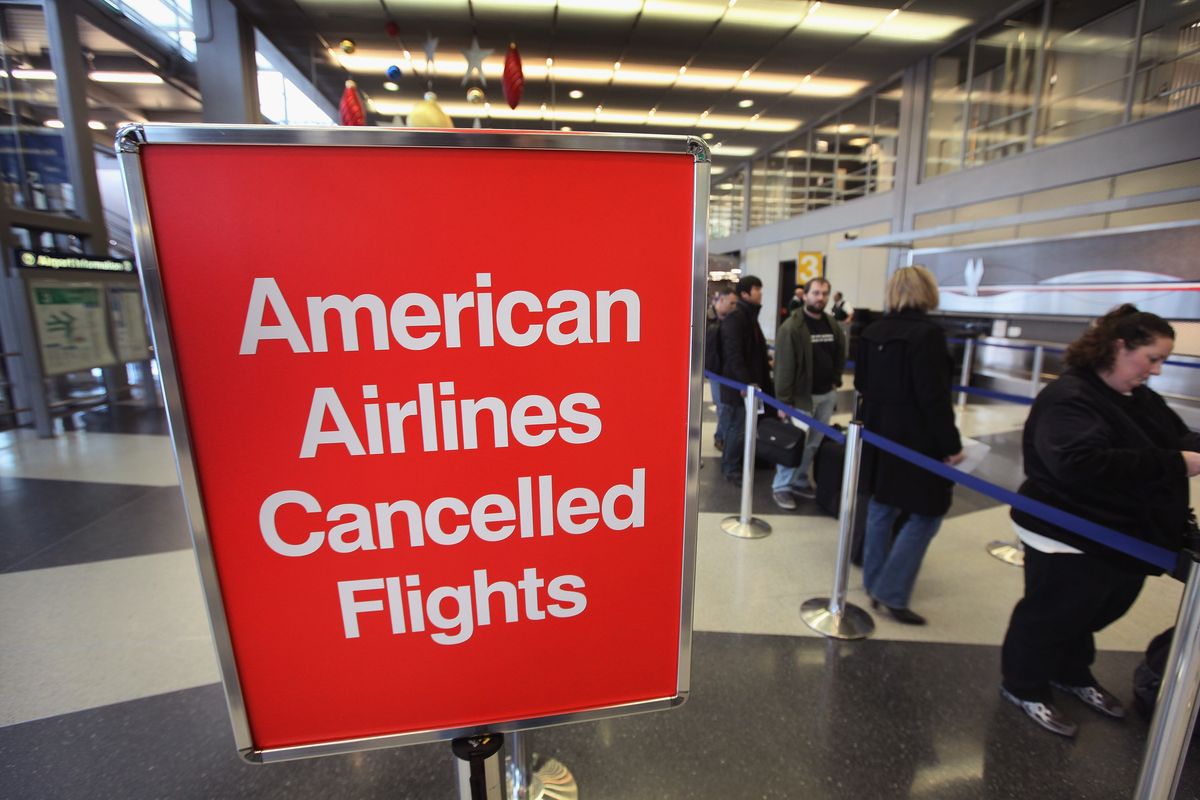 American Airlines passengers wait in line at O’Hare Airport to rebook flights canceled by weather on Nov. 29, 2011, in Chicago.  (Scott Olson/Getty Images North America/TNS)