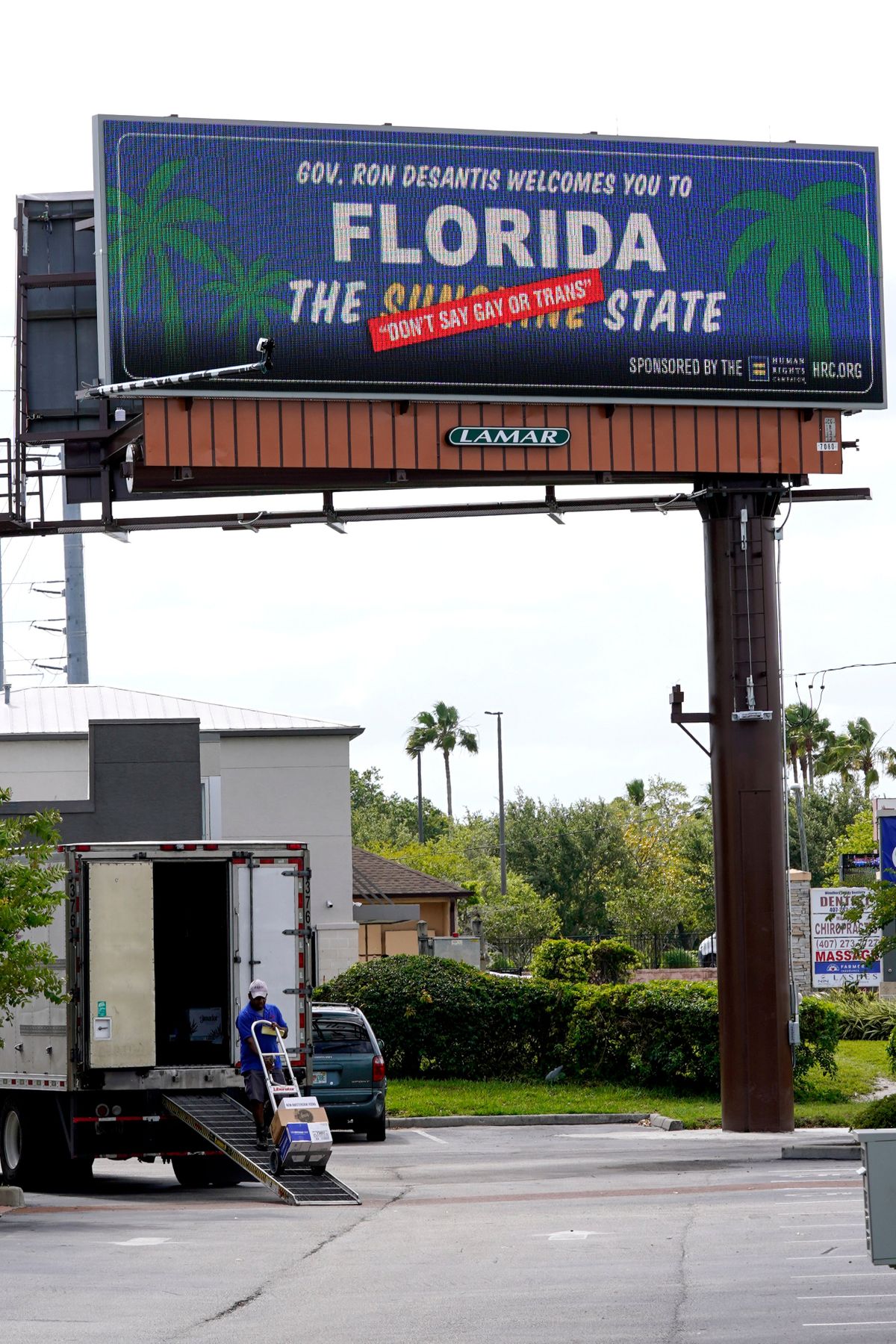FILE - A new billboard welcoming visitors to "Florida: The Sunshine 'Don't Say Gay or Trans' State. is displayed April 21, 2022, in Orlando, Fla. The Florida Legislature has passed a bill to dissolve a private government controlled by Disney that provides municipal-like services for its 27,000 acres in the Sunshine State. The proposal has been pushed by Republican Gov. Ron DeSantis, and is largely viewed as retribution for Disney’s criticism of a new state law that bars instruction on sexual orientation and gender identity in kindergarten through third grade.  (John Raoux)