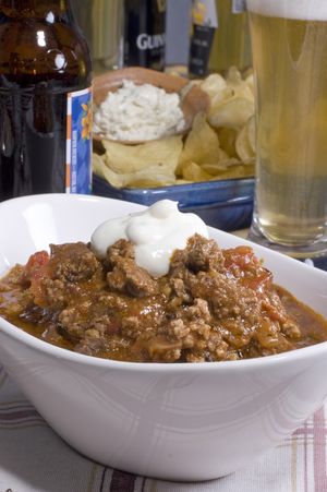 All-or-Nothing Chili features classic spices plus coffee, ginger and cinnamon in a toasted seasonings base. Add pork, beef and buffalo for a half-time favorite. (Associated Press)