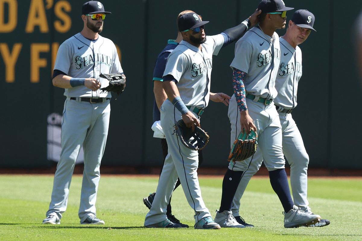 Seattle’s Julio Rodriguez, front right, leaves the game against the Oakland Athletics in the bottom of the first inning Thursday in Oakland, California.  (Lachlan Cunningham)