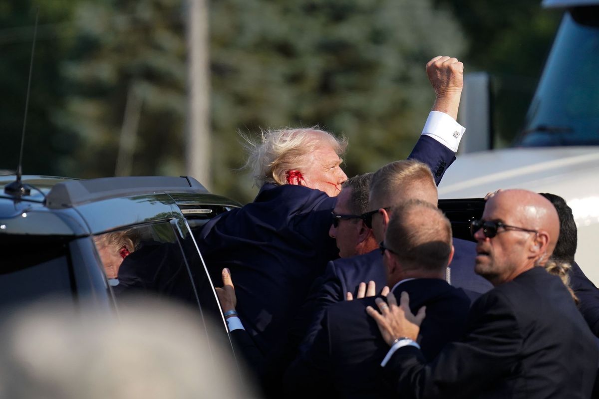Members of Secret Service assist former president Donald Trump into a vehicle during a campaign rally for former President Donald Trump at Butler Farm Show Inc. on Saturday in Butler, Pa.   (Jabin Botsford/Washington Post)