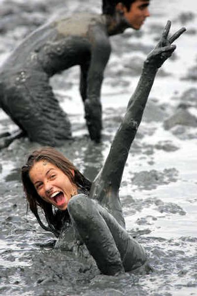 
A woman celebrates after jumping into the mud during a street carnival Saturday in Paraty, Brazil.
 (Associated Press / The Spokesman-Review)