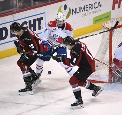 Spokane Chiefs forward Graham Sward (7) competes for control of the puck with Vancouver Giants forward Michal Kvasnica (38) and Vancouver Giants forward Cole Shepard (16) during the first period of a WHL hockey game, Fri., Jan. 10, 2020, in the Spokane Arena.  (COLIN MULVANY/THE SPOKESMAN-REVIEW)