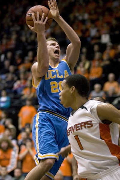 UCLA’s Michael Roll goes to the hoop against Jared Cunningham of Oregon State.  (Associated Press)