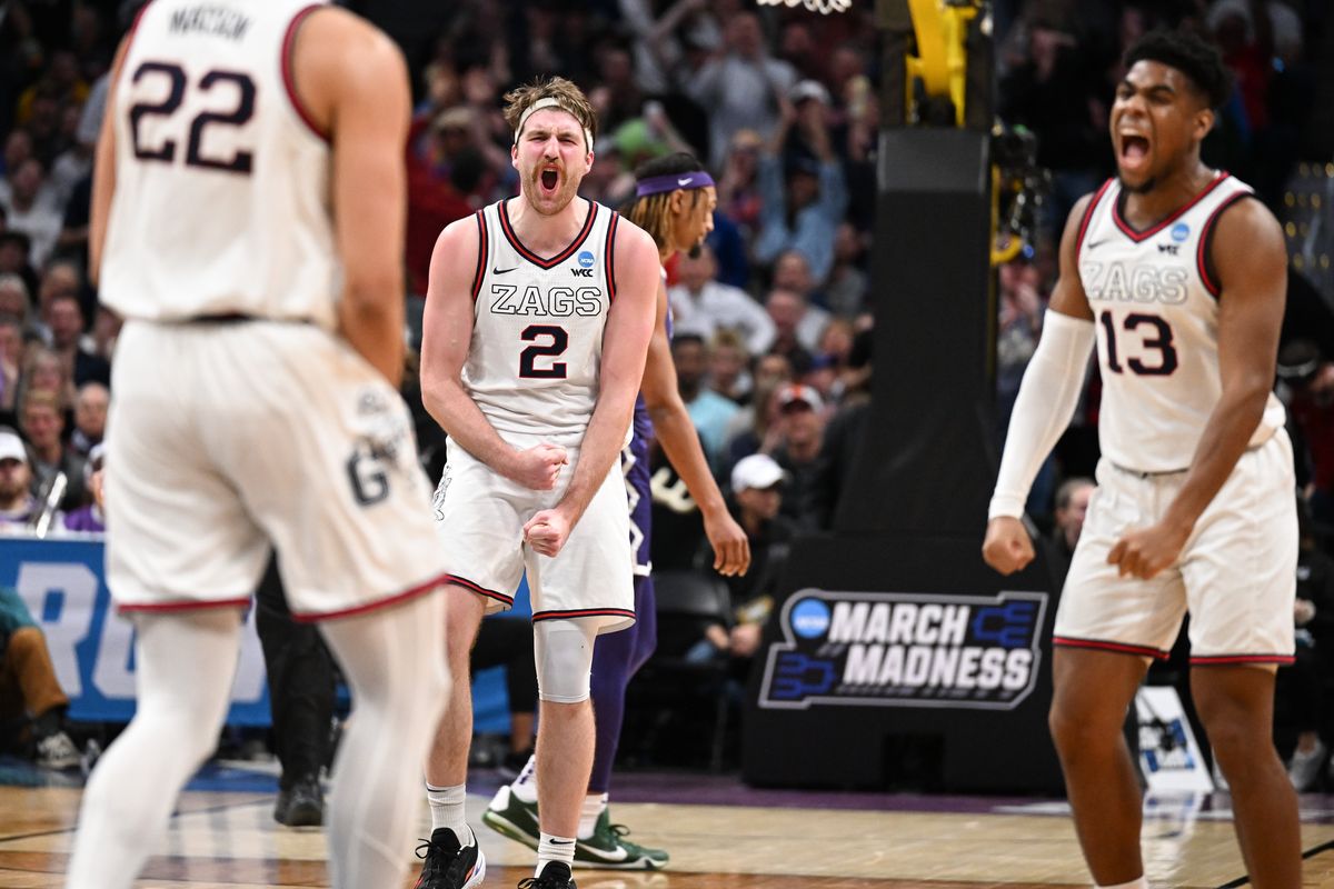 Gonzaga Bulldogs forward Drew Timme (2) and guard Malachi Smith (13) celebrate after forward Anton Watson (22) dunked the ball against the TCU Horned Frogs during the second half of a second round NCAA Basketball Tournament game on Sunday, March 19, 2023, at Ball Arena in Denver, Colo. Gonzaga won the game 84-81.  (Tyler Tjomsland/The Spokesman-Review)