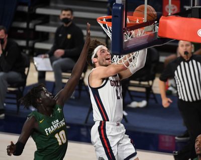 Gonzaga forward Corey Kispert smiles on his way to an easy layup against San Francisco Dons forward Josh Kunen during a Jan. 2 West Coast Conference home game.  (Colin Mulvany/The Spokesman-Review)