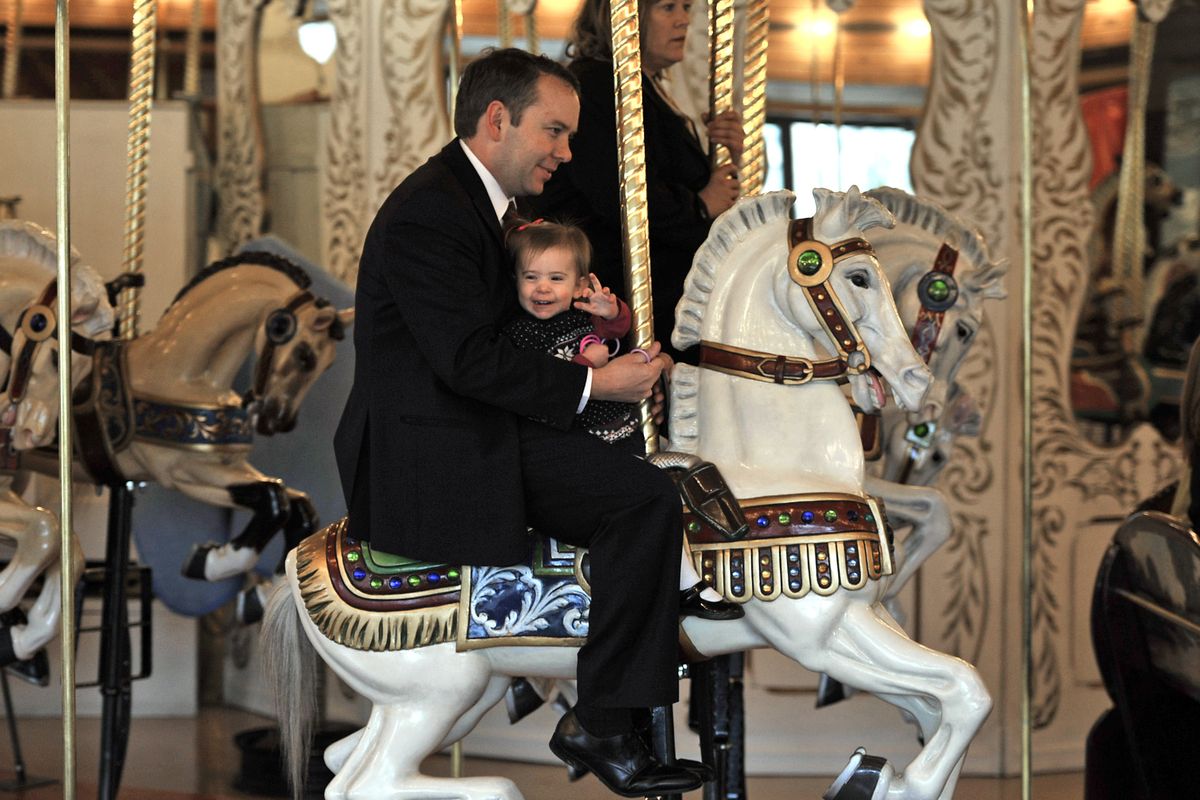 Spokane’s new mayor, David Condon, celebrates with his daughter, Hattie, 1 1/2 years old, on the Looff Carrousel after a swearing-in ceremony. (Dan Pelle)
