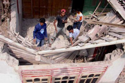 
Residents remove rubble in a search for survivors in a damaged house in Bantul, Yogyakarta, Central Java, Indonesia, on Saturday, following a massive earthquake earlier in the day. 
 (Associated Press / The Spokesman-Review)