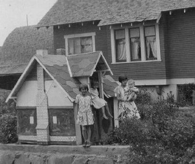 
 John Flemming of Harrington, Wash., built this playhouse for his children in 1929. He also built the house in the background. The Fleming children, from left, are Dorothy, Marguerite and Laura, who is holding 1-year-old Robert. The house is still there, but the playhouse is long gone. 
 (Photo courtesy of Robert Flemming / The Spokesman-Review)