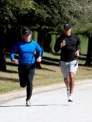 Tiger Woods, right, jogs with an unidentified friend near his home Wednesday, Feb. 17, 2010, in Windermere, Fla. Woods will end nearly three months of silence Friday when he speaks publicly for the first time since his middle-of-the-night car accident sparked stunning revelations of infidelity. It will be Woods' first public appearance since Nov. 27. (Sam Greenwood / Pool Getty Images)
