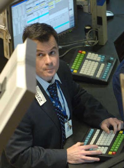 
Michael McDonnell of Van der Moolen Specialists looks at a monitor from the floor of the New York Stock Exchange on Wednesday. The Dow Jones industrials were up more than 300 points after a Federal Reserve official hinted that the central bank may lower interest rates again. Associated Press
 (Associated Press / The Spokesman-Review)