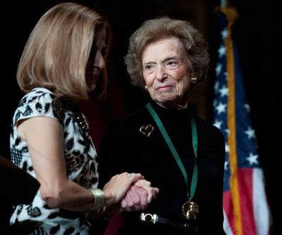 Then-California first lady Anne Gust Brown, left, walks on the stage with Gap clothing store chain founder Doris Fisher after she was inducted along with her late husband Donald, during the 2011 California Hall of Fame Induction Ceremony on Dec. 8, 2011, in Sacramento, Calif.  (Reuters )